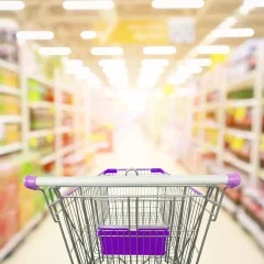 supermarket-aisle-product-shelves-interior-blur-background-with-empty-shopping-cart_293060-4045